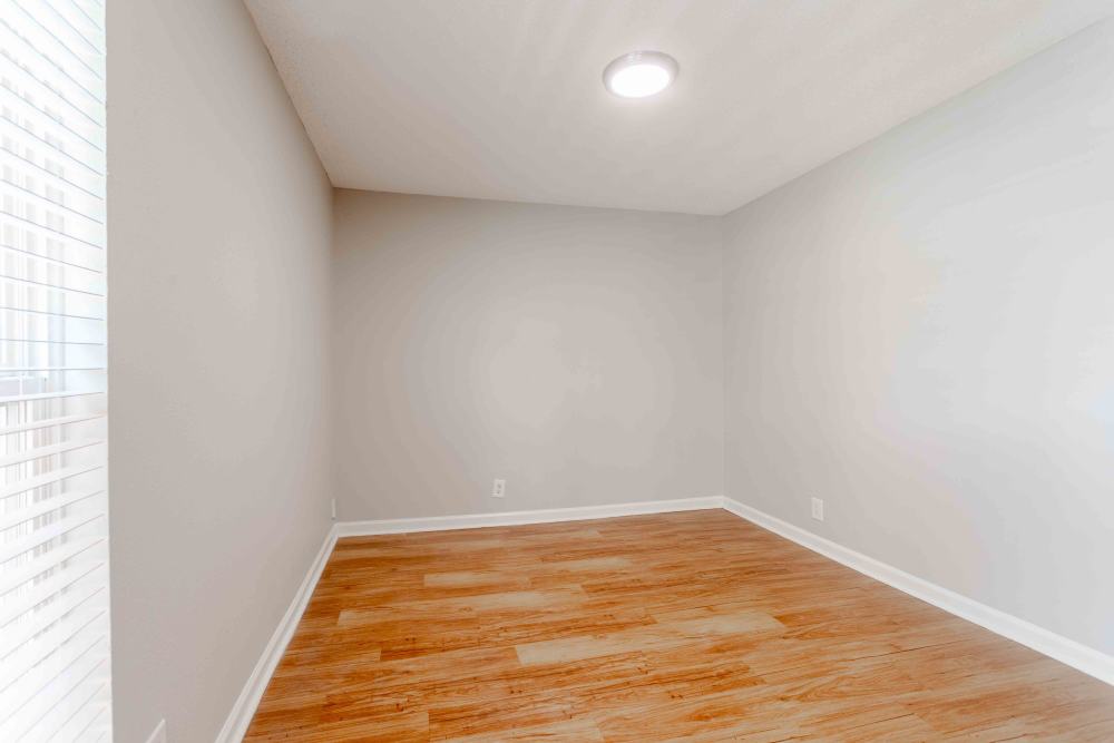 Empty room featuring hardwood floors and white walls, creating a bright and spacious atmosphere at 865 Bellevue Apartments in Nashville, Tennessee