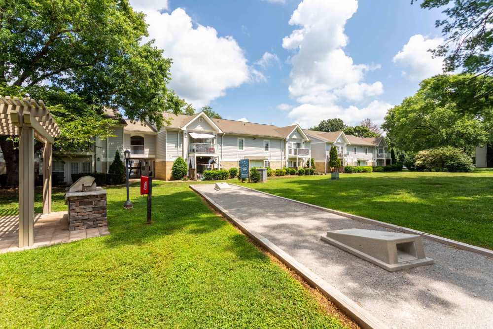 Lush green park area featuring trees, benches, and walking path at 865 Bellevue Apartments in Nashville, Tennessee