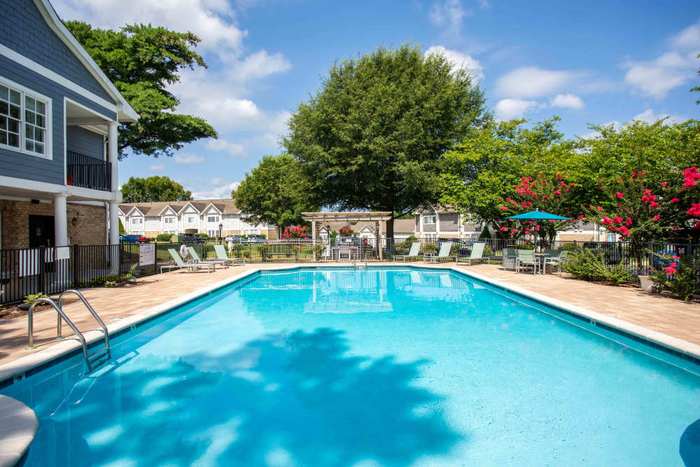 The pool area at the featuring lounge chairs and a serene atmosphere at 865 Bellevue Apartments in Nashville, Tennessee