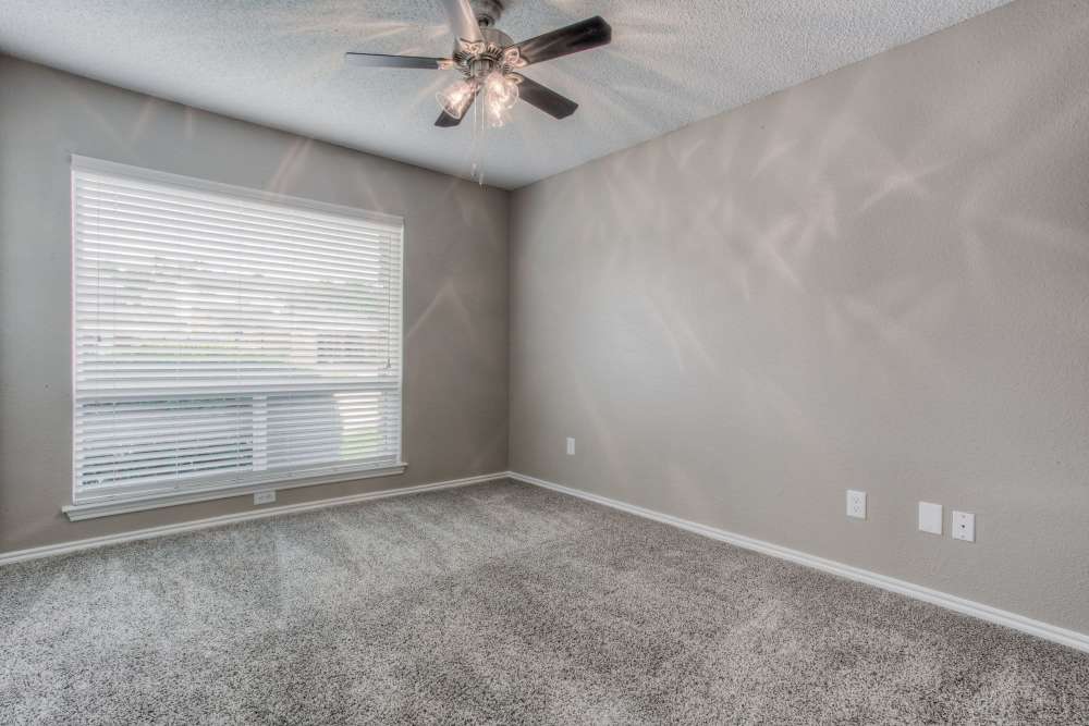 Unfurnished bedroom with carpet flooring and large windows at The Quorum At Trophy Club in Trophy Club, Texas