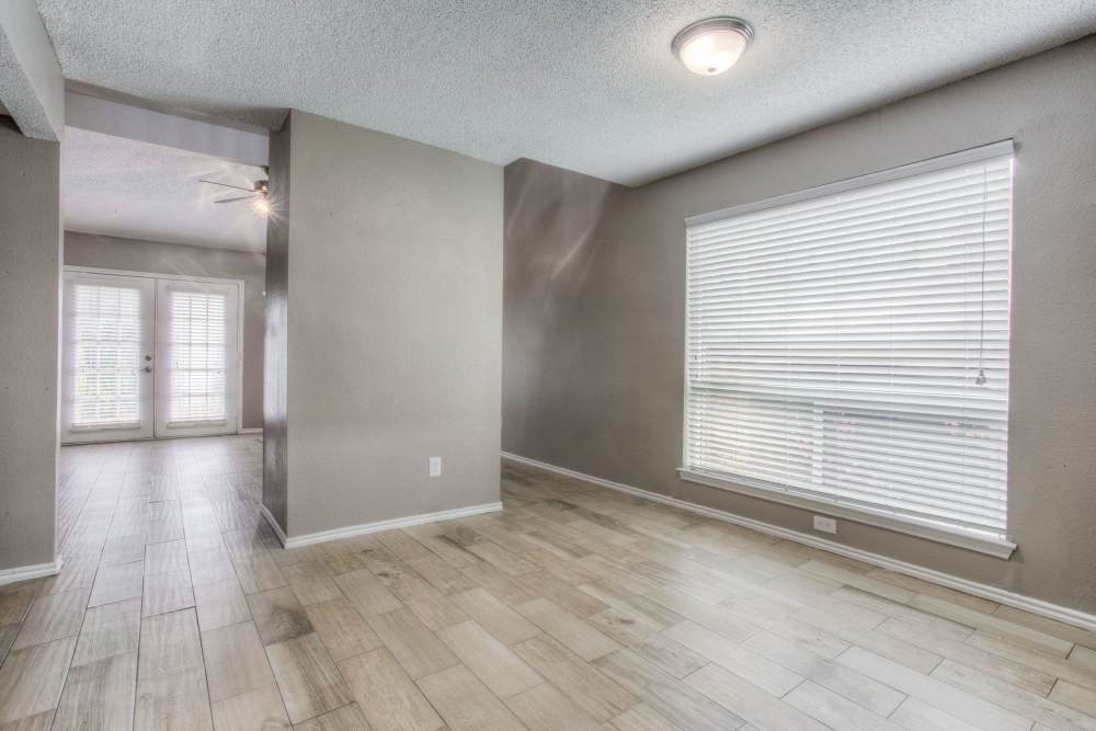 Unfurnished room with large window and wood flooring at The Quorum At Trophy Club in Trophy Club, Texas
