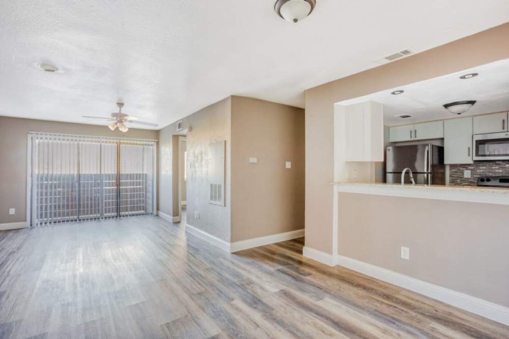 Open layout living room with sliding door at Hubbards Ridge in Garland, Texas