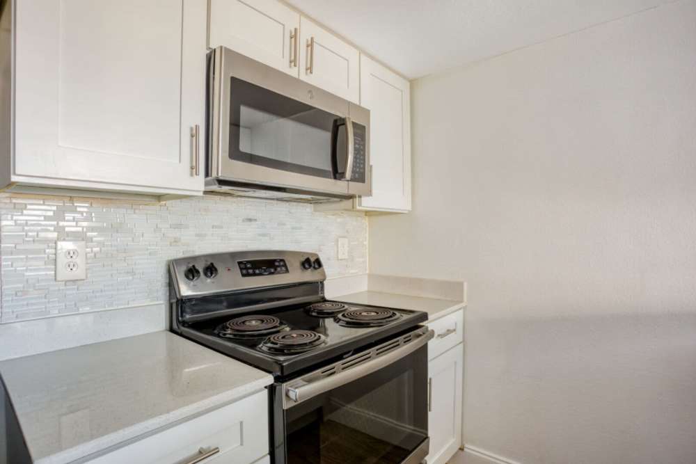 Kitchen with white cabinets at Hubbards Ridge in Garland, Texas