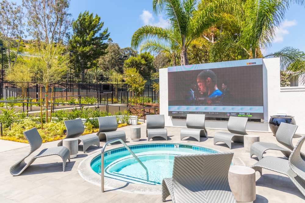 Lounge chairs around the spa, next to a large LED screen at Marea in Dana Point, California