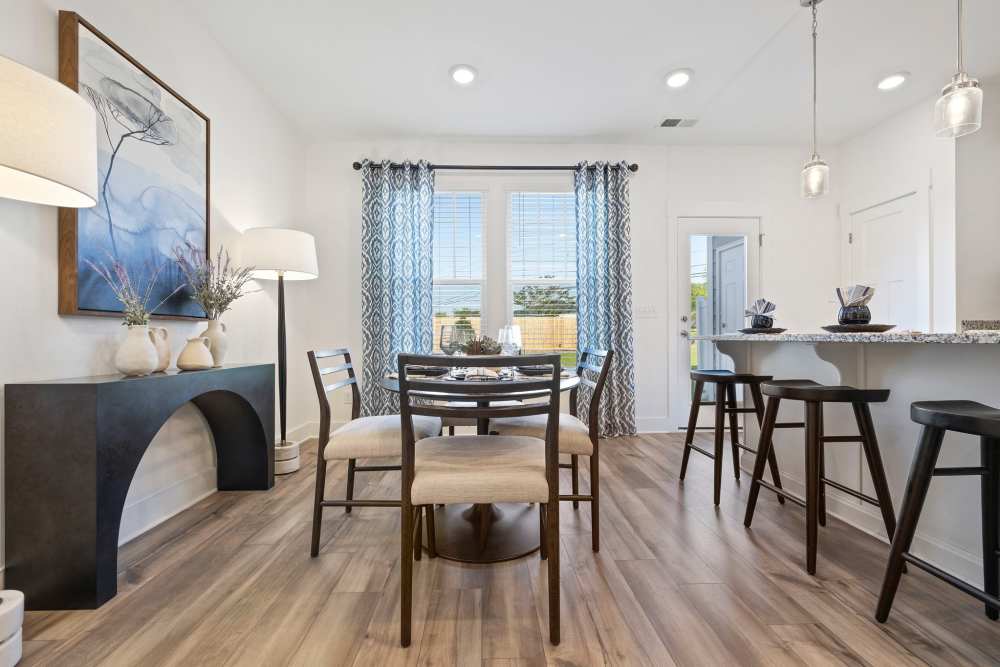Dining and kitchen area with bar stools at Artisan Living Mills River in Mills River, North Carolina