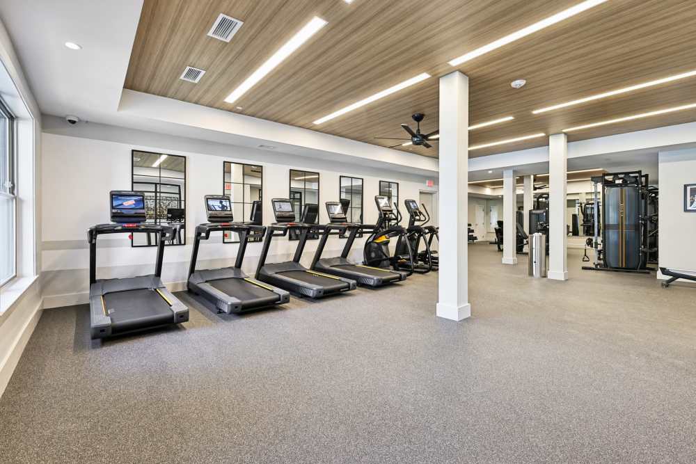 Resident fitness center with four treadmills and two elliptical machines at  Elms Shady Grove in Rockville, Maryland