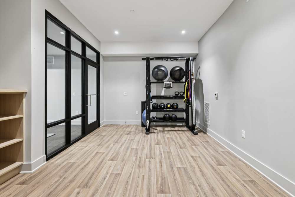 Resident fitness center with private fitness room and training balls and bells at  Elms Shady Grove in Rockville, Maryland