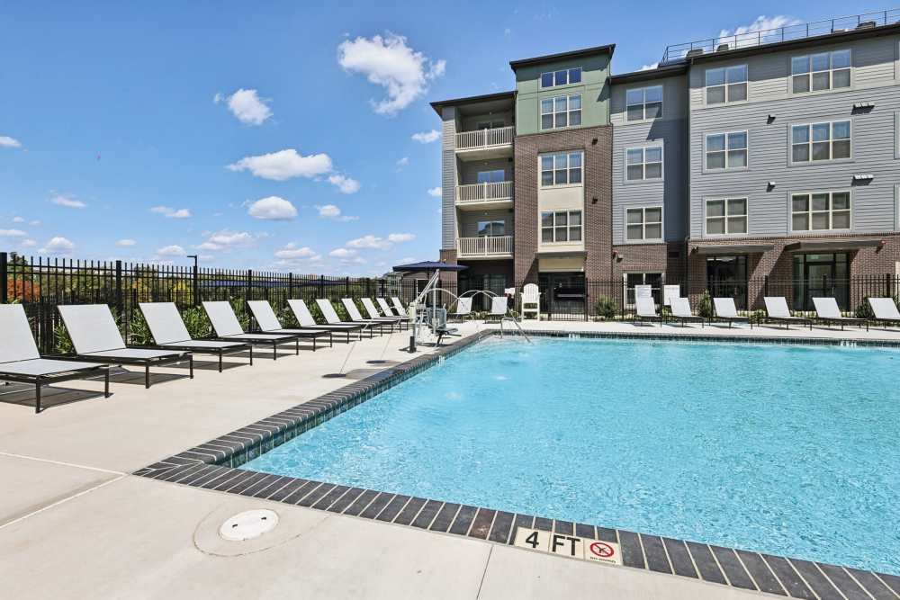 Private pool with sundeck and lounge chairs at Elms Shady Grove in Rockville, Maryland