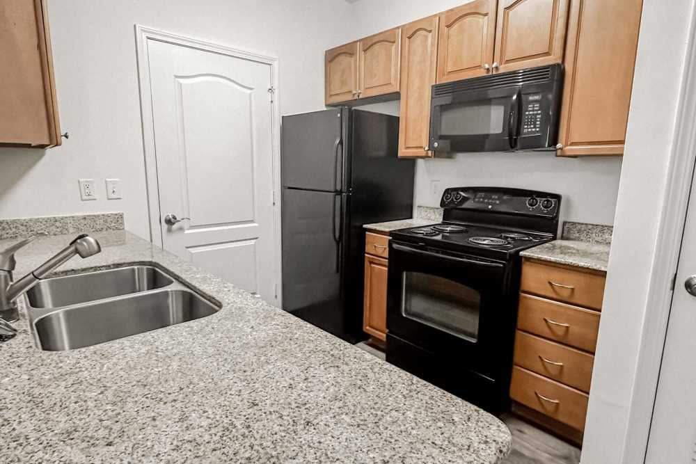 Apartment kitchen with wooden cabinets at Windsor Upon Stonecrest in Burlington,North Carolina