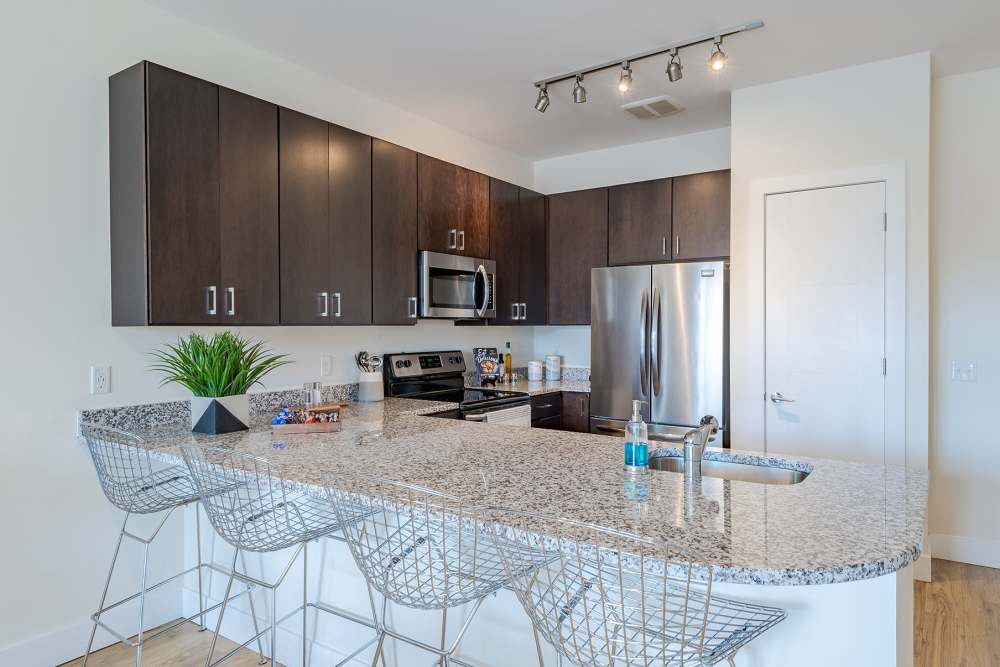 kitchen with barstool seating at The Residences at Annapolis Junction in Annapolis Junction, Maryland