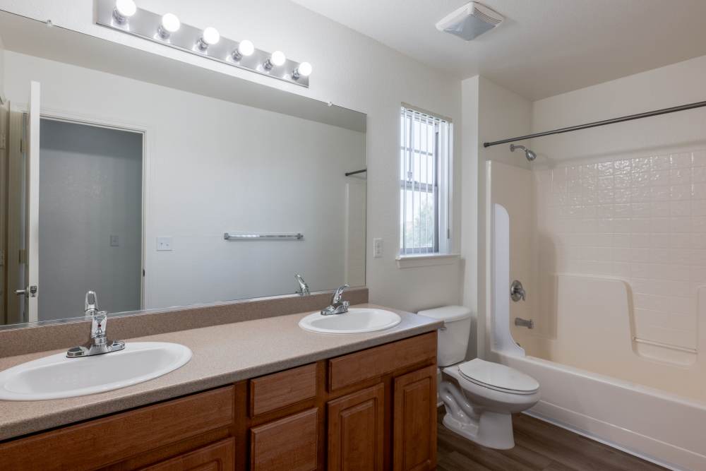 Dual sink bathroom with shower and bath combo at Reagan Park in Lemoore, California