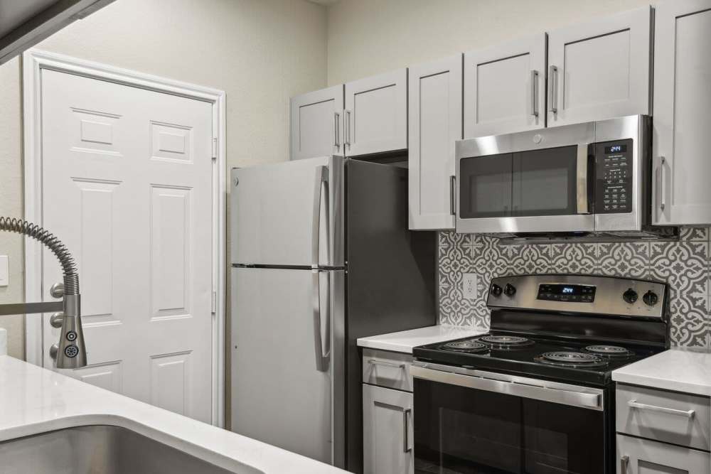 Apartment kitchen with stainless-steel appliances at Charleston in San Antonio,Texas
