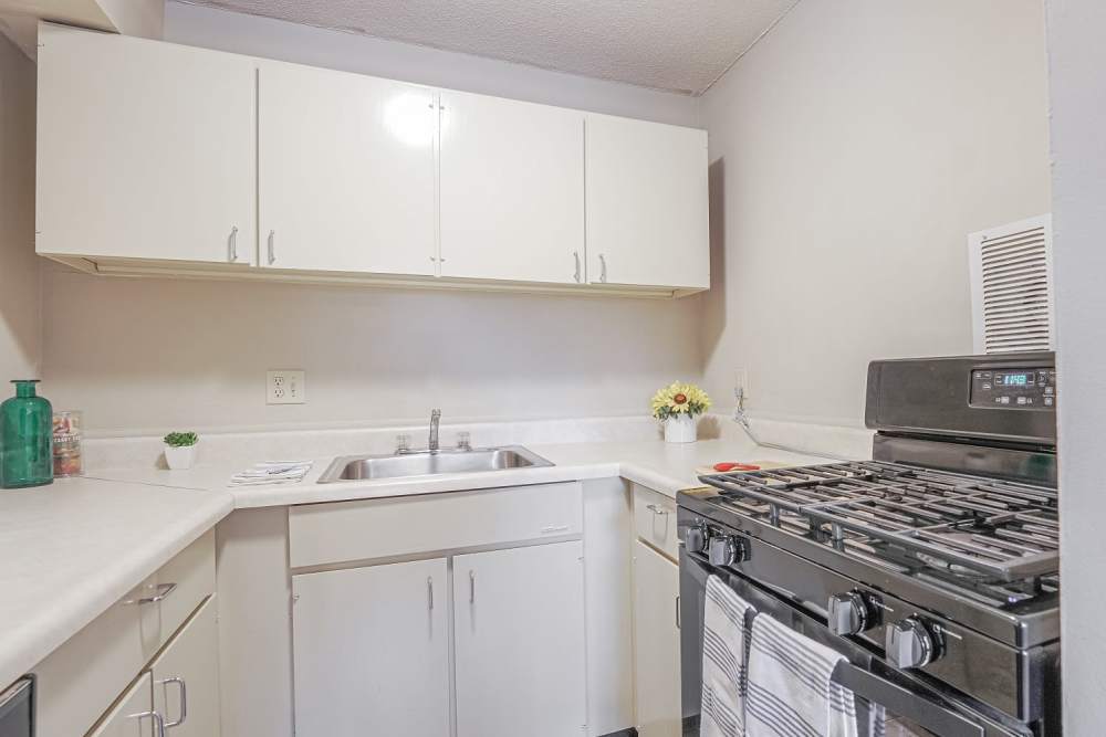 Kitchen with white appliances at Courtyard Apartments in Columbia,Missouri