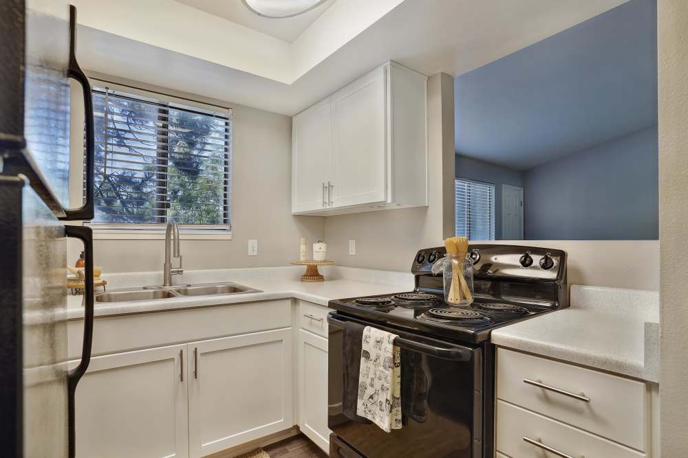 Kitchen with black appliances at Royal Farms Apartments in Salt Lake City, Utah