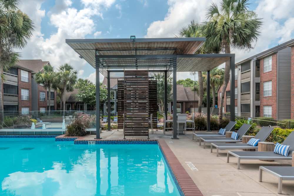Community swimming pool with lounge chairs at The Haven On Buoy in Webster,Texas