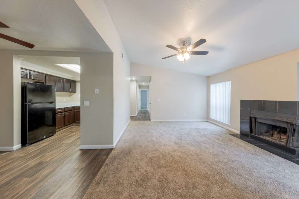 Carpeted living room with fireplace at The Lodge at McCarran Ranch Apartment Homes in Reno, Nevada
