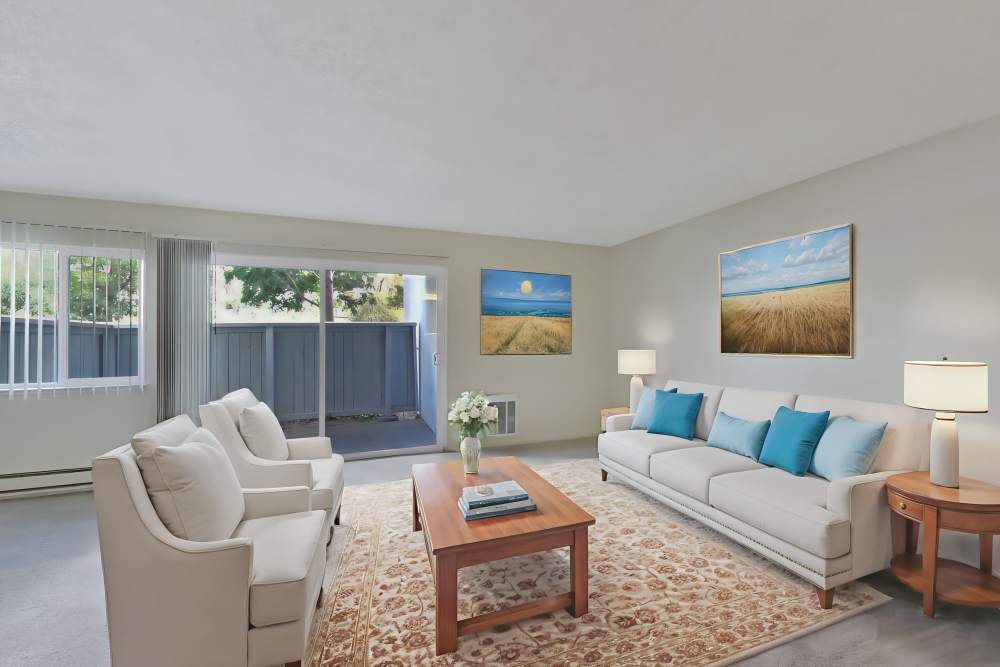 Living room with access to patio at Lakeside Village in San Leandro, California