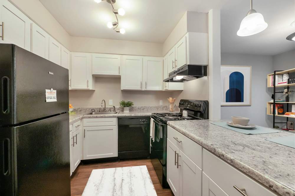 Well-lit kitchen with marble counter top at Riverside North Apartment Homes in Chattanooga, Tennessee