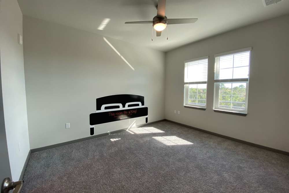 Unfurnished bedroom with carpet flooring and a window at Murano at Three Oaks in Fort Myers,Florida