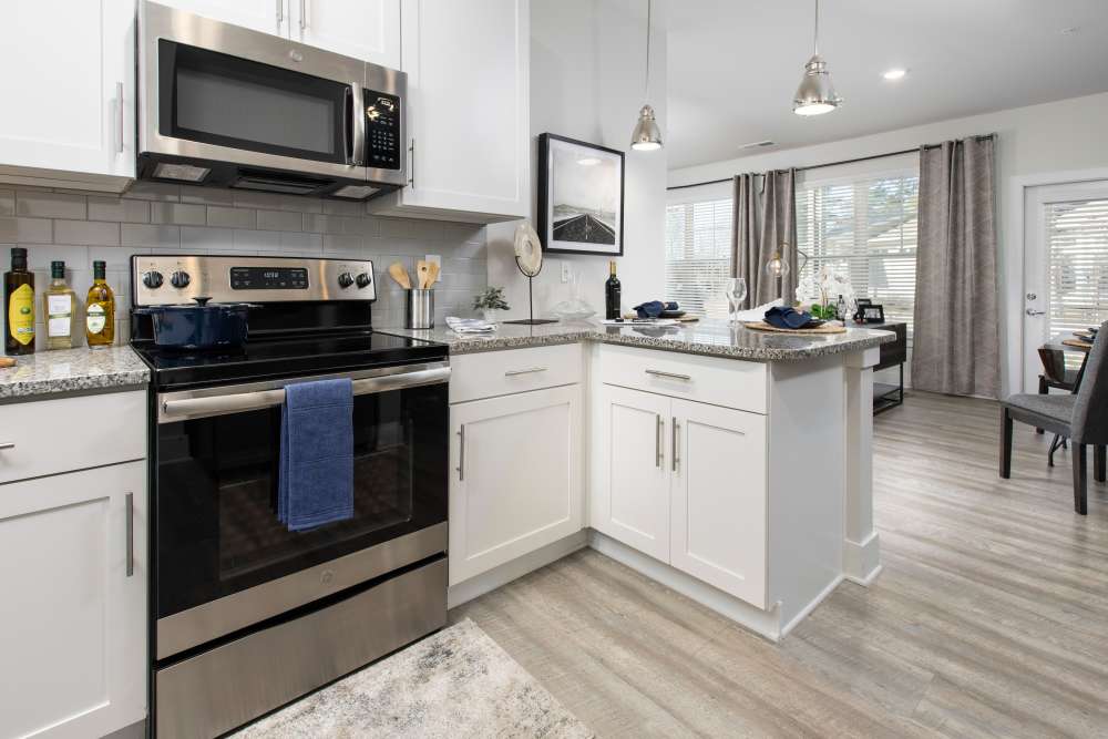 Kitchen with white color cabinet at South City Apartments in Summerville, South Carolina