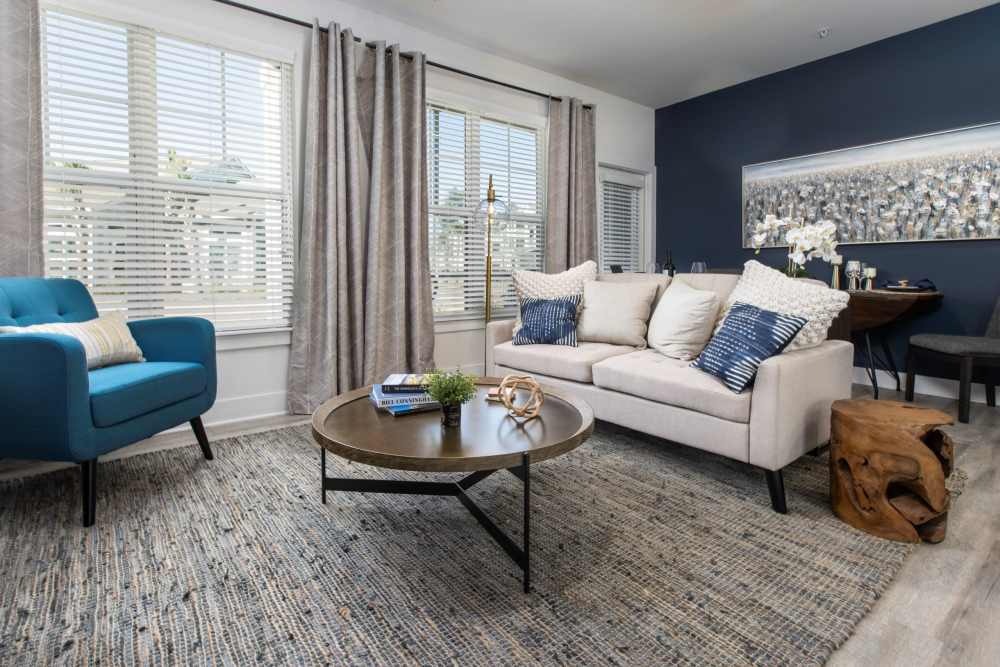 Living room with large window at South City Apartments in Summerville, South Carolina