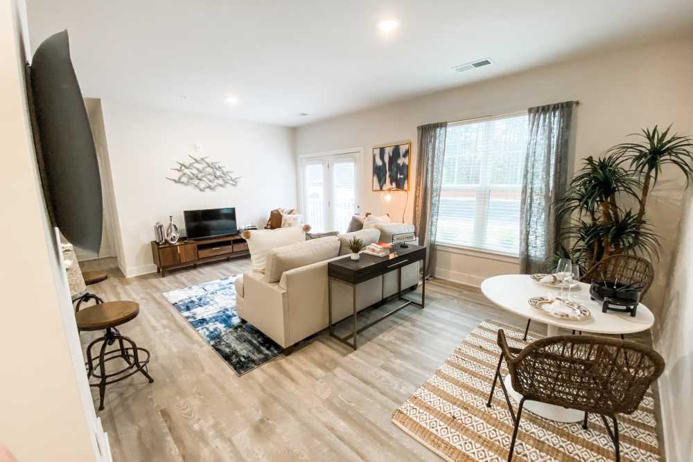 Living room with wooden flooring at South City Apartments in Summerville, South Carolina