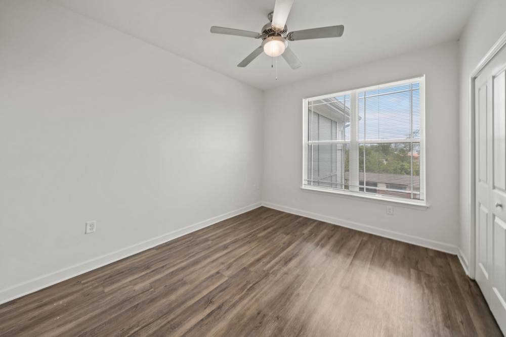 Bedroom with a ceiling fan and a window at The Park at Massalina in Panama City,Florida