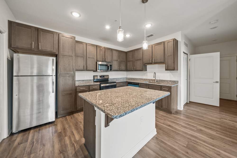 Apartment kitchen with wood-style flooring at The Park at Massalina in Panama City,Florida