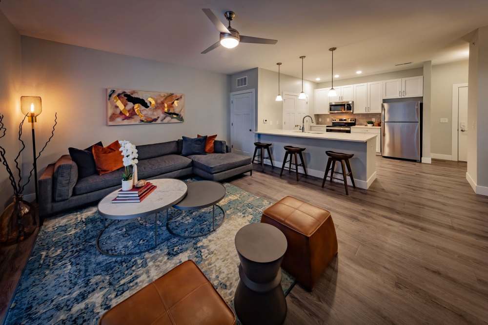 Modern living room with kitchen at Flats at Stones Crossing in Greenwood, Indiana