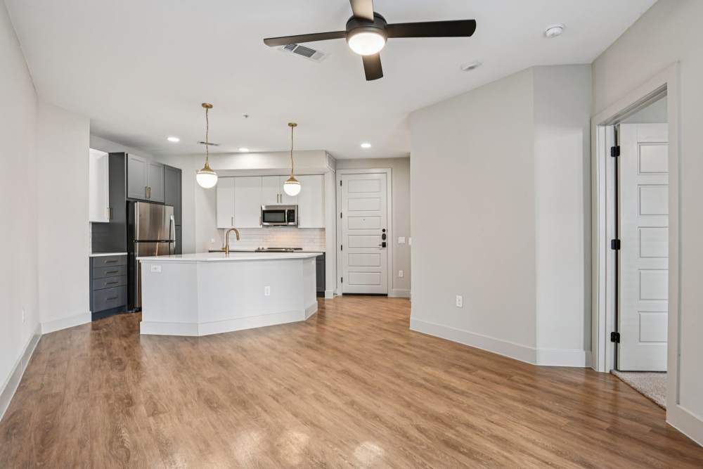 Living room adjacent to kitchen at Vance at Bishop Union in Dallas, Texas