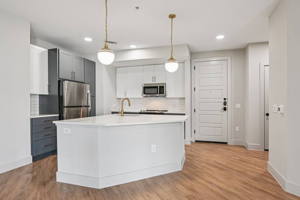 Kitchen with counter isle at Vance at Bishop Union in Dallas, Texas