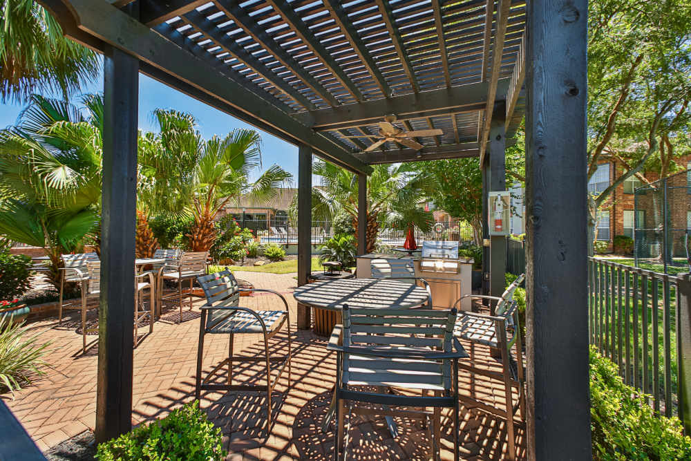 Outdoor seating area with lots of trees at Barnett in Houston, Texas