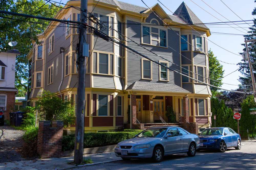 Exterior of the building with parking in the front at Jamaica Plain Scattered Site in Jamaica Plain,Massachusetts