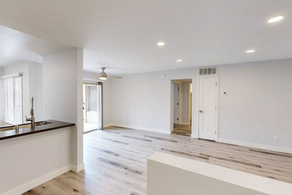 Open layout of kitchen and living room with sink, and storage at The Indie Glendale Collection in Glendale, California