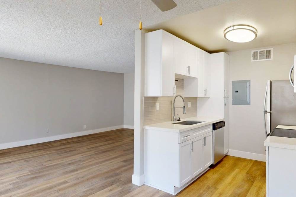 Kitchen island with Dishwasher, stainless steel sink, with waterfall faucet and ceiling light at The Indie Glendale Collection in Glendale, California
