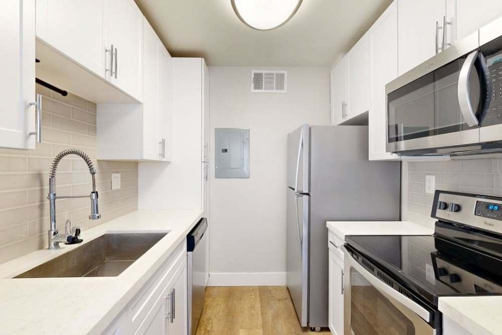 Fully equipped kitchen with stainless steel appliances at The Indie Glendale Collection in Glendale, California