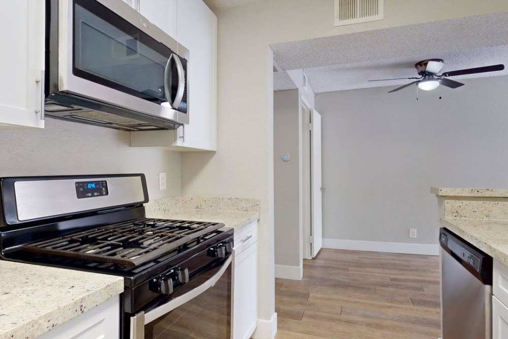 Apartment kitchen with dual color Appliances and white colored cabinets at The Indie Glendale Collection in Glendale, California
