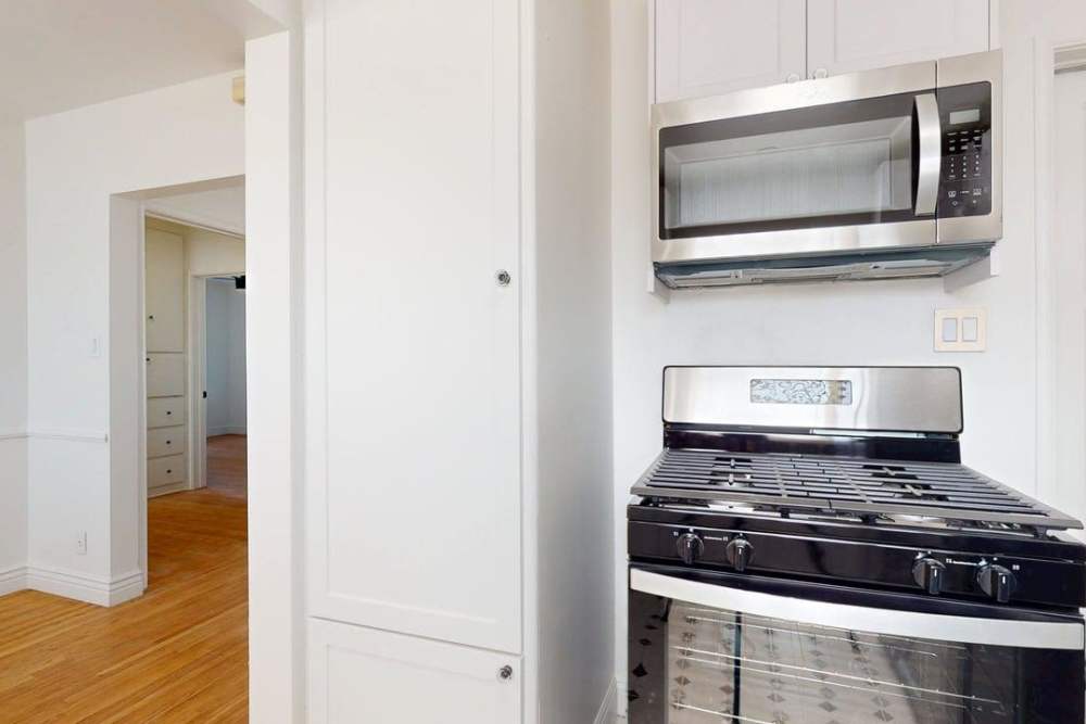 White cabinet kitchen with dual color appliances at The Indie Glendale Collection in Glendale, California