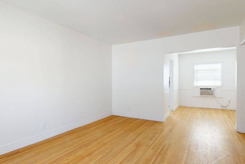 Empty living room with wood flooring at The Indie Glendale Collection in Glendale, California