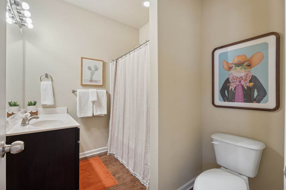 Bathroom with shower, tub, toilet and vanity at Cottage Row Stillwater in Stillwater, Oklahoma