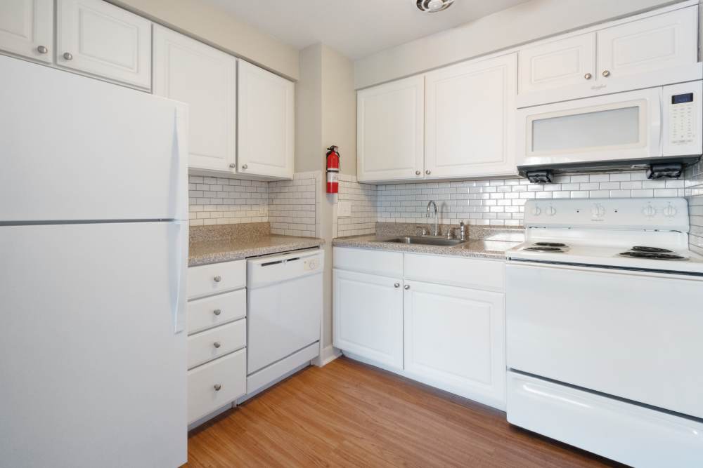 classic kitchen with white cabinets and appliances at Aston Pointe Apartments in Aston, Pennsylvania