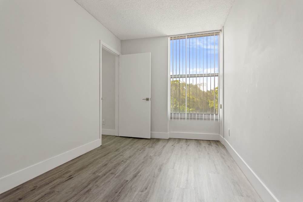 Model bedroom with large window in Forest Place