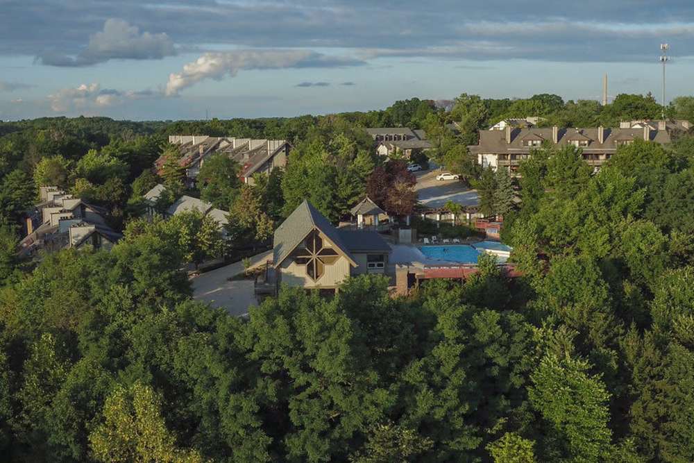 Aerial view of the community in the trees at Merriman Valley Apartments and Townhomes in Akron, Ohio