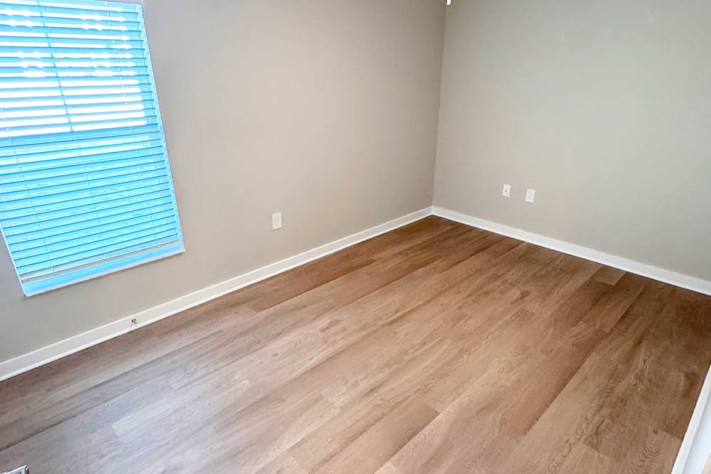 Unfurnished bedroom with wood-style flooring at Addison Grove in Avon Park,Florida