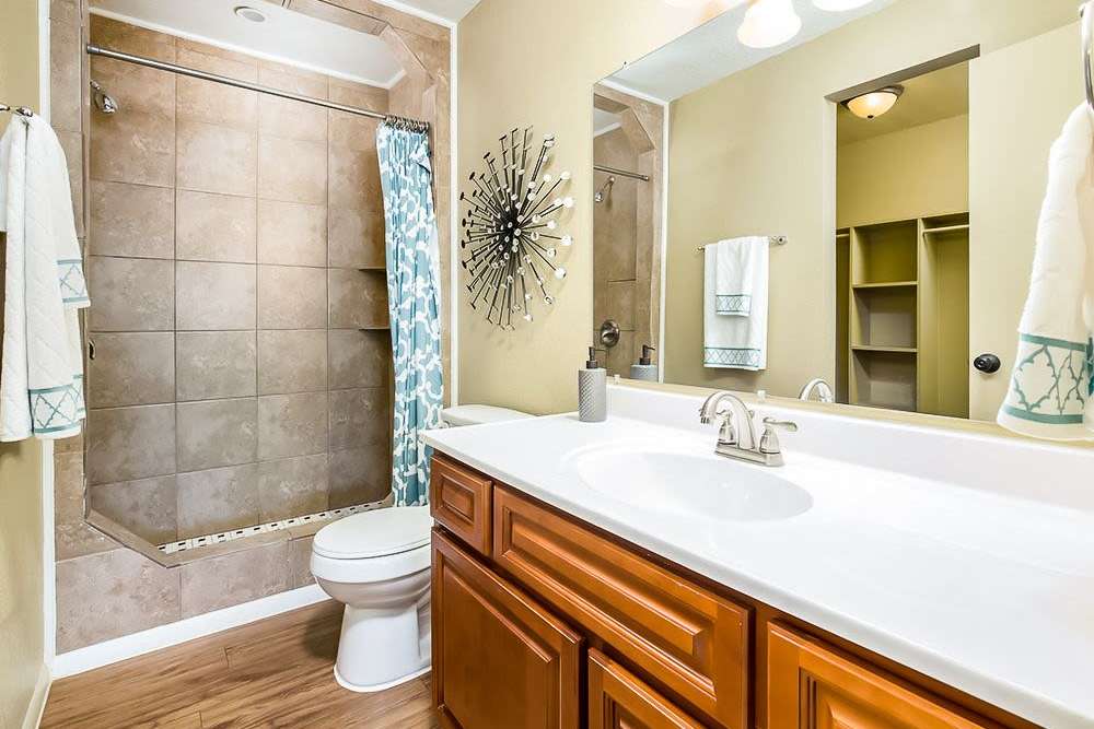 Bathroom with vanity mirror at Council Crossing in Bethany, Oklahoma