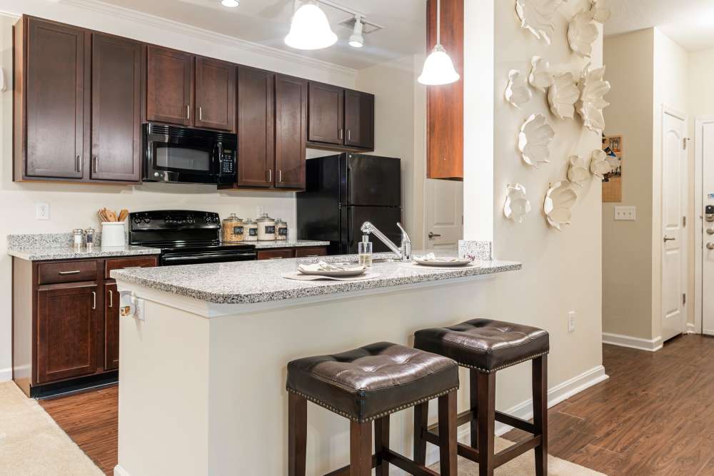 Equipped kitchen with counter at Oasis at Montclair Apartments in Dumfries, Virginia