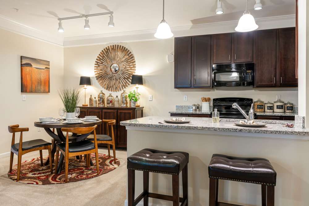 Kitchen counter with two stools at Oasis at Montclair Apartments in Dumfries, Virginia