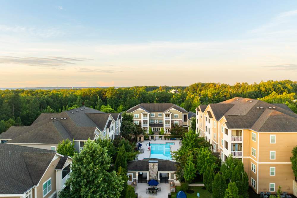 Aerial shot of the community with the pool in the middle at Oasis at Montclair Apartments in Dumfries, Virginia