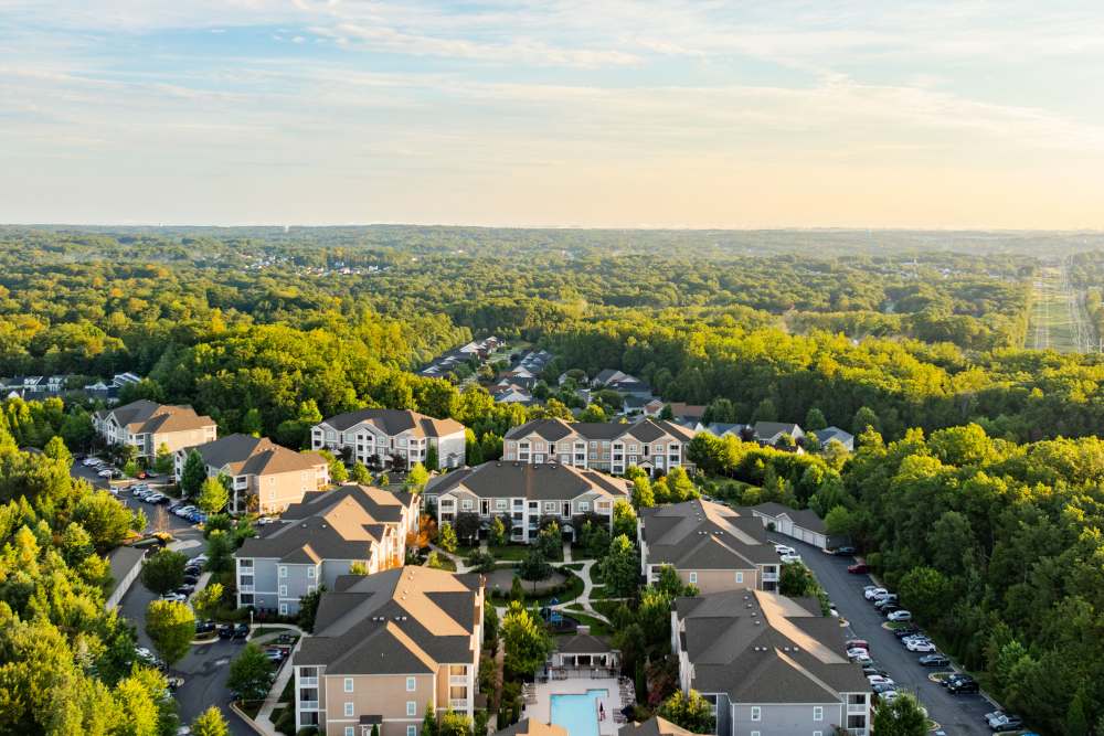 Aerial shot of the community showcasing many trees at Oasis at Montclair Apartments in Dumfries, Virginia