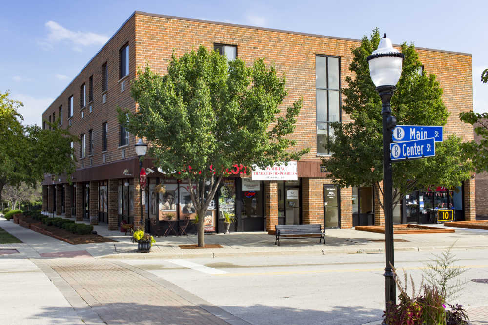 A beautiful wide exterior view of apartments at Main Street Apartments in Bensenville, Illinois